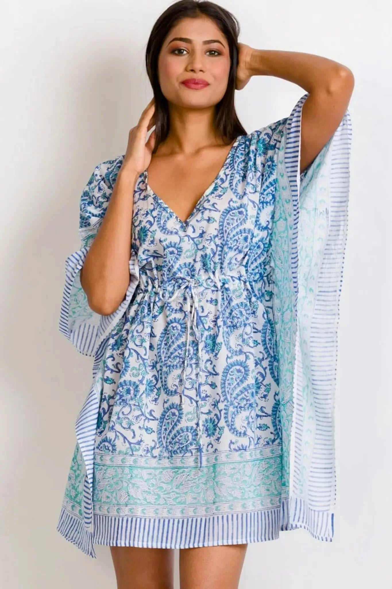 Sky Blue Caftan with turquoise paisley print and drawstring waist, styled as a boho beach cover-up or mini dress. Lightweight and flowy design.