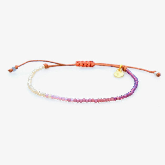 Stay Wild Moon Child Boho Bead Bracelet with pink, purple and white shimmery beads on an adjustable size cotton cord