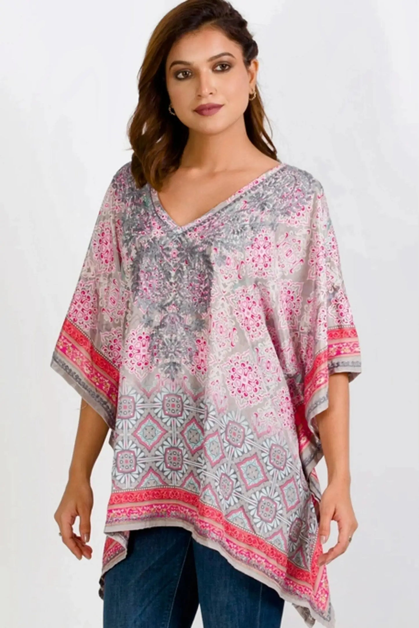 The Taneesha Embroidered Tunic Top pullover style v-neck, long length, sharkbite hem and flattering kimono style short sleeves.