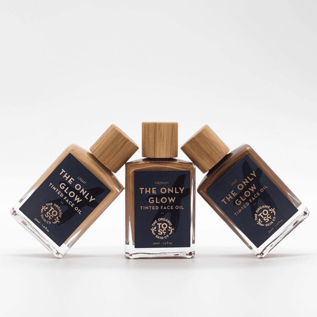 The Only Glow - Hydrating Organic Foundation Serum in three shades with bamboo caps, offering natural, buildable coverage and hydration.