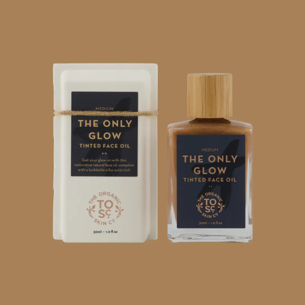 The Only Glow - Hydrating Organic Foundation Serum in a glass bottle with a wooden cap, paired with eco-friendly packaging. A tinted face oil offering buildable coverage and hydration.