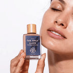 Foundation Serum bottle held by a woman with glowing skin. A luxurious tinted face serum for hydration and natural coverage.