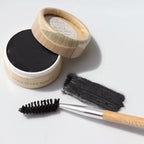 Black Cake mascara product in an eco-friendly container with a brush on a light background