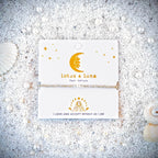 Pearl and Crystal Bracelet on a card with 'lotus & luna' branding on sand surrounded by seashells.