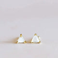 White Mother of Pearl triangle stud earrings set in gold by JaxKelly, minimalist gemstone earrings for elegant everyday wear.