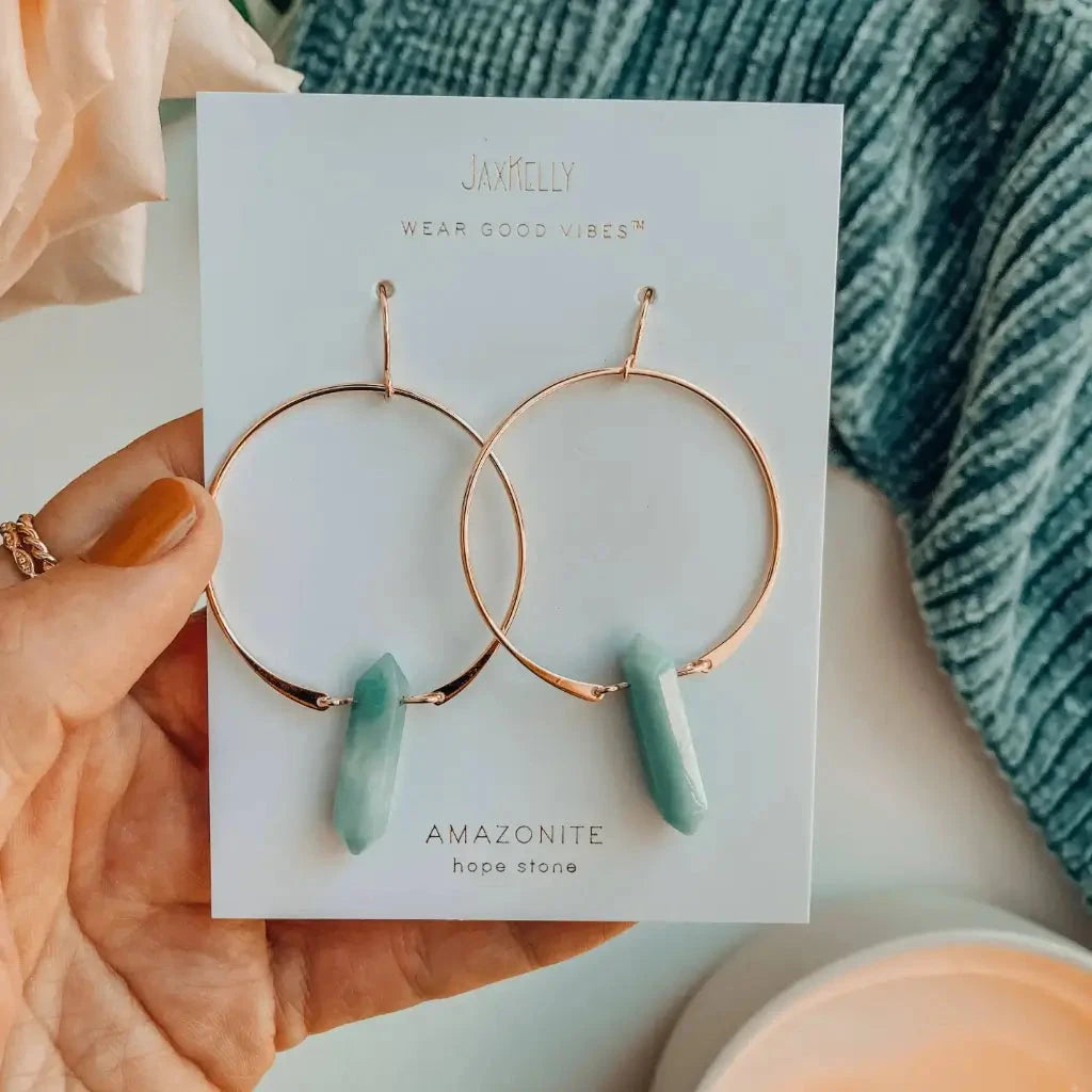 Gold hoop earrings with Amazonite stones on a Jaxkelly branded card.