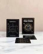 Yoga cards with illustrations and text on a marble surface. Yoga Pose and Meditation Cards for Adults by High Desert Yogi.