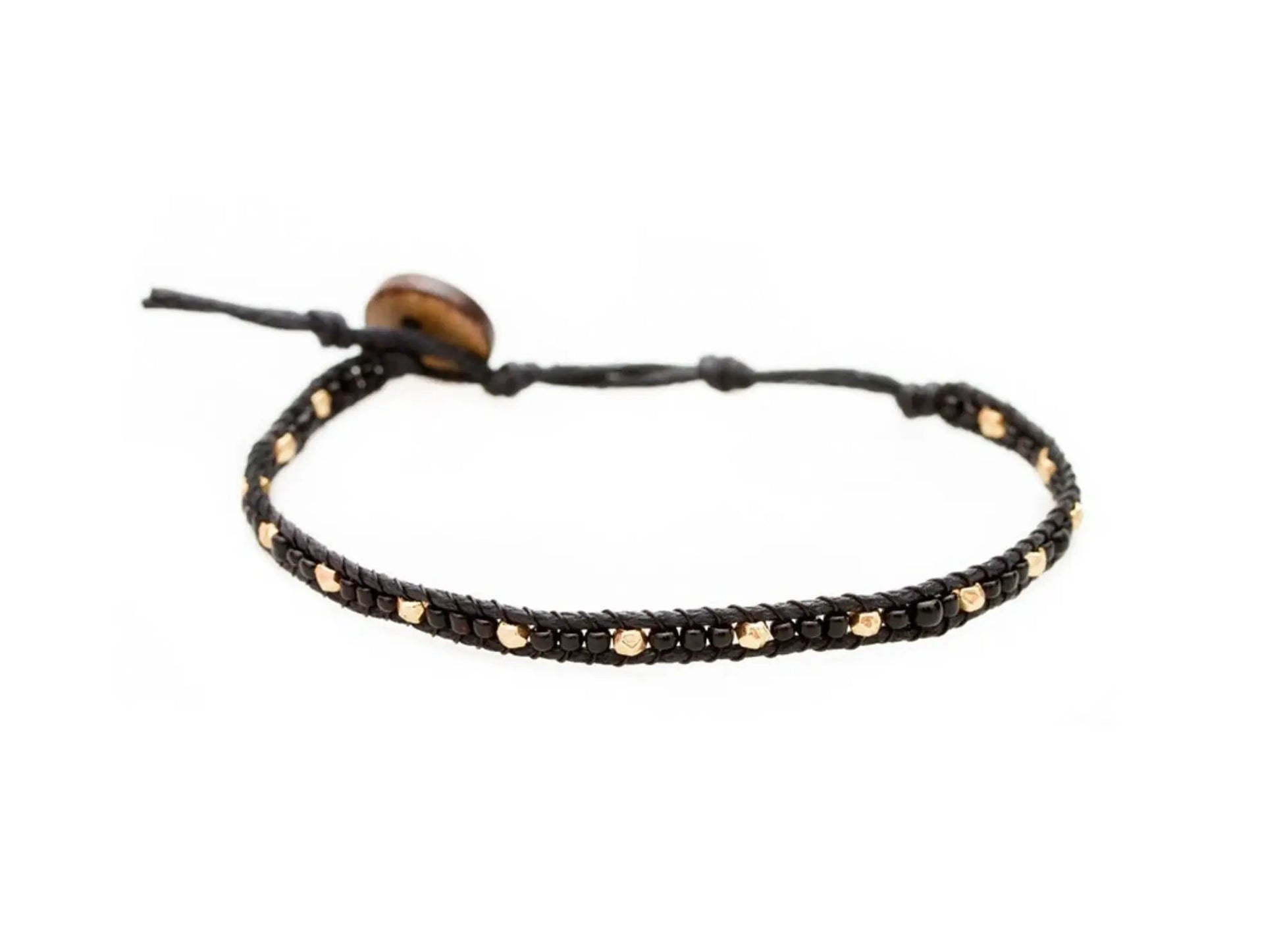 Lotus and Luna Ball Drop Bracelet. Black and gold seed beads on an adjustable cotton cord with coconut button closure.